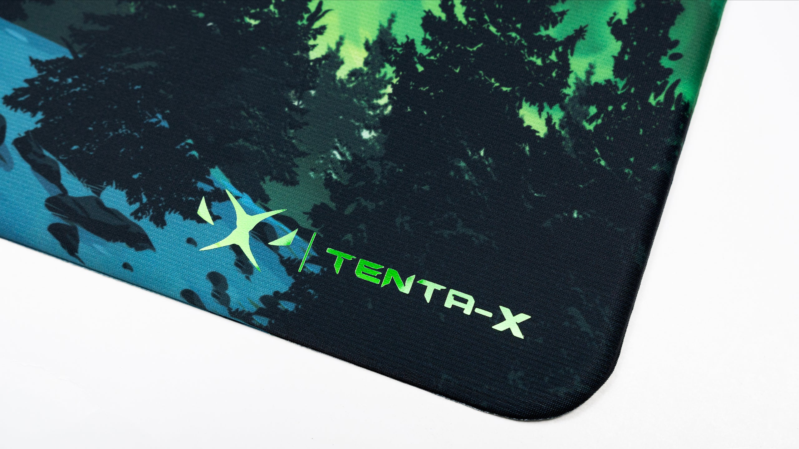 TENTA-X JadeFire Shinkiro fastest esports mousepad - premium edge detail 
with brand logo, smooth rounded edge construction, and forest aurora 
design with vibrant green borealis colors for competitive gaming